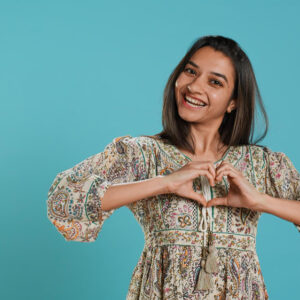 Happiest woman show feedback with heart.